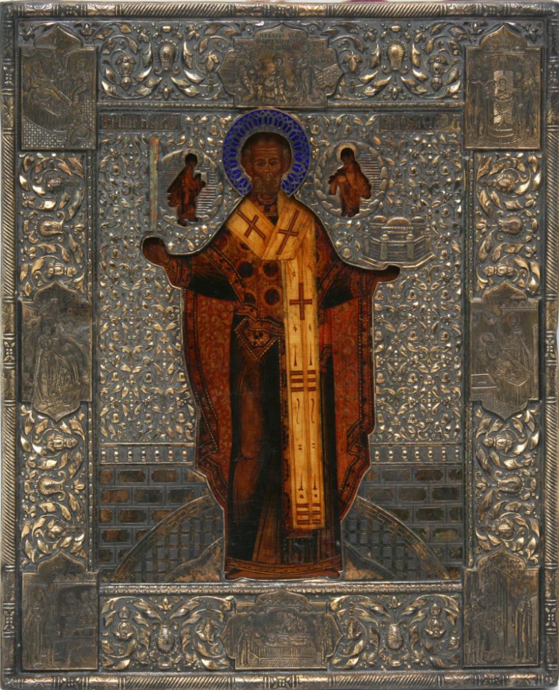 Оклад для иконы Николая Можайского. Вторая половина XIX века. Серебро, золочение, чернь, гравировка в торцах и углах сцен жития святого, чеканка в технике высокого орнамента «гречкой», выемчатая эмаль. 